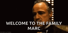 a man in a tuxedo is talking on a cell phone and says welcome to the family marc