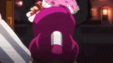 a person is holding a purple object in their hand