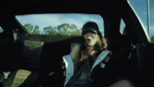 a woman is sitting in the back seat of a car with the word bride on the back seat