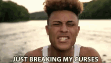 a young man is making a funny face with the words just breaking my curses behind him