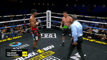 two boxers in a boxing ring with a sign that says golden boy on it