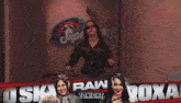 a woman stands in a hallway with a sign that says raw tonight on it