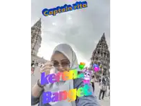 a woman wearing a hijab and sunglasses is standing in front of a building with captain rita written on it
