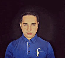 a man wearing a blue shirt with the letter f on the chest