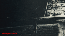 a black and white photo of a body of water with the words #weaponsmovie written in red