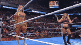 two women in a wrestling ring with a smackdown sign behind them