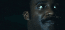 a close up of a man 's face with his eyes closed