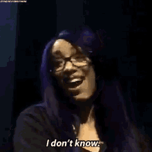 a woman with purple hair is saying `` i don 't know '' .