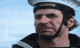 a man wearing a seasprite hat is looking at the camera