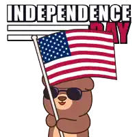 a teddy bear wearing sunglasses holds an american flag in front of a sign that says " independence day "