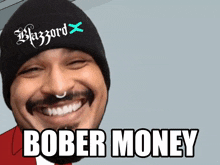 a man wearing a black beanie with the words blizzard on it