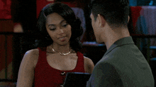 a man and a woman are looking at each other