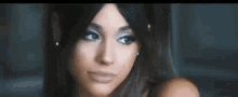 a close up of ariana grande 's face with a serious look on her face .
