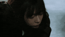 a close up of a woman 's face with a black background