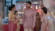 a man and two women are standing next to each other