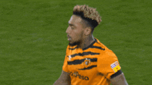 a soccer player wears a jersey that says sportpesa
