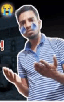 a man with blue paint on his face is making a funny face while wearing a striped shirt .