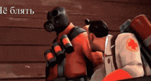 a man in a gas mask stands next to a woman in a white shirt with a red cross on it