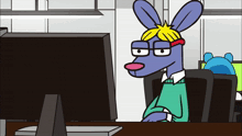 a cartoon rabbit is sitting at a desk looking at a computer monitor