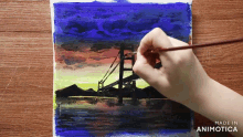 a person is painting a bridge with the words made in animotica behind them