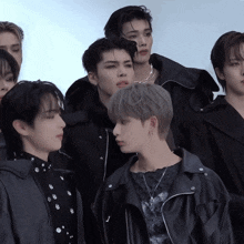 a group of young men are posing for a picture and one of them is wearing a necklace