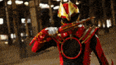 a red and gold superhero holding a sword