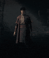 a woman is standing in a dark forest wearing a red coat and black skirt