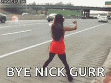 a woman in a red dress is dancing on the side of a highway with the words bye nick gurr written below her