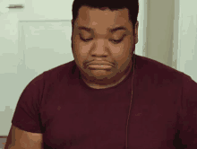 a man is wearing headphones and making a funny face .