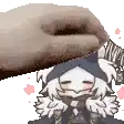 a close up of a hand holding a cartoon character 's head .