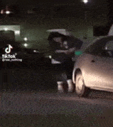 a woman is dancing in front of a car .