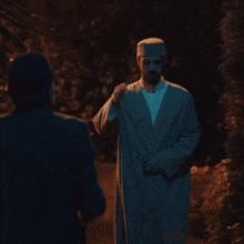 a man with a beard wearing a white hat is walking with another man