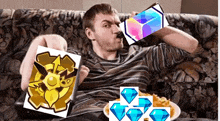 a man is sitting on a couch drinking from a bottle and holding a picture of a shield and diamonds .