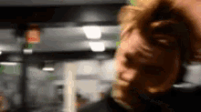 a blurry picture of a man 's face with his hand on his head