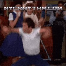 a man with his arms outstretched is dancing in front of a nycrhythm.com logo