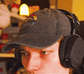 a man wearing headphones and a hat that says tuf on the front