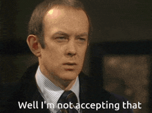 a man in a suit says well i 'm not accepting that