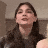 a close up of a woman 's face with her mouth open .