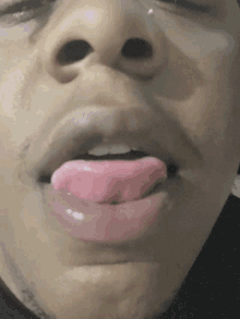 a close up of a person 's mouth with their tongue out
