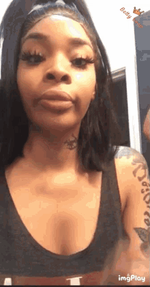 a woman with a tattoo on her neck is looking at herself in the mirror
