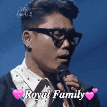 a man singing into a microphone with the words royal family written above him