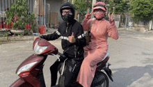 a man and a woman are riding a honda motorcycle