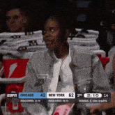 a woman sits in the stands watching a chicago vs new york game