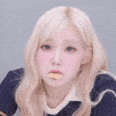 a close up of a woman eating a piece of food .