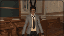 a man with bunny ears and glasses stands in a classroom