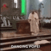 a priest is dancing in a church with the words dancing pope written on the bottom .