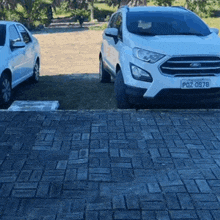 a white ford car has a license plate that says pdz 0978