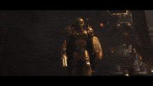 a man in gold armor is holding a gun and a shield