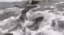 a black and white photo of a person standing in the ocean .