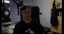 a blurry picture of a person 's face with a black shirt on